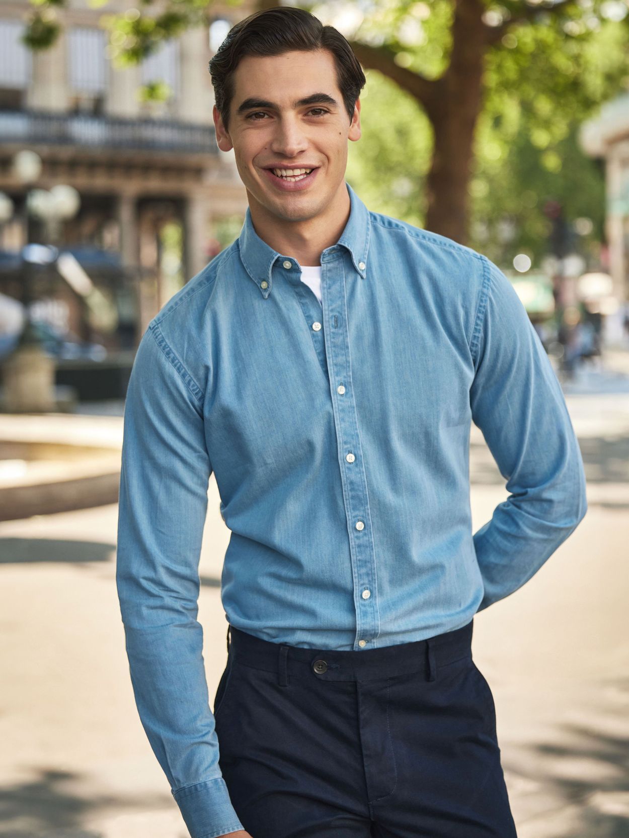 Man wearing a denim overshirt, white T-shirt and white pants with